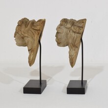Pair small weathered carved oak head ornaments, France circa 1650