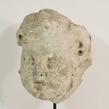 Weathered stucco/stone paste fragment of an angel head, France circa 1650-1750