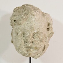 Weathered stucco/stone paste fragment of an angel head, France circa 1650-1750