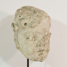 Weathered stucco/stone paste fragment of an angel head, France circa 1650-1750