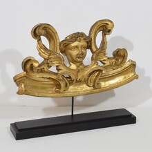 Carved giltwood ornament with winged angel head, France circa 1900