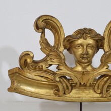 Carved giltwood ornament with winged angel head, France circa 1900