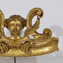 Carved giltwood ornament with winged angel head, France circa 1900