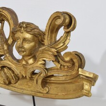 Carved giltwood ornament with winged angel head, France circa 1900