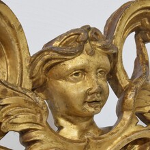 Carved giltwood ornament with winged angel head, France circa 1900