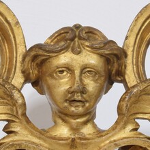 Carved giltwood ornament with winged angel head, France circa 1900