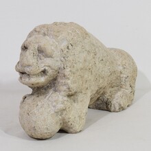 Carved stone lion holding a ball, Italy circa 1650-1750