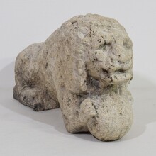 Carved stone lion holding a ball, Italy circa 1650-1750