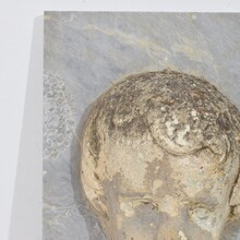 Carved stone cherub fountain head on marble panel, Italy circa 1650-1750