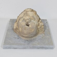 Carved stone cherub fountain head on marble panel, Italy circa 1650-1750