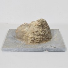 Carved stone cherub fountain head on marble panel, Italy circa 1650-1750