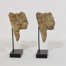 Pair small weathered carved oak head ornaments, France circa 1650