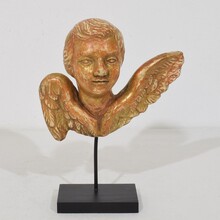 Small baroque carved giltwood angel head on wings, France circa 1750
